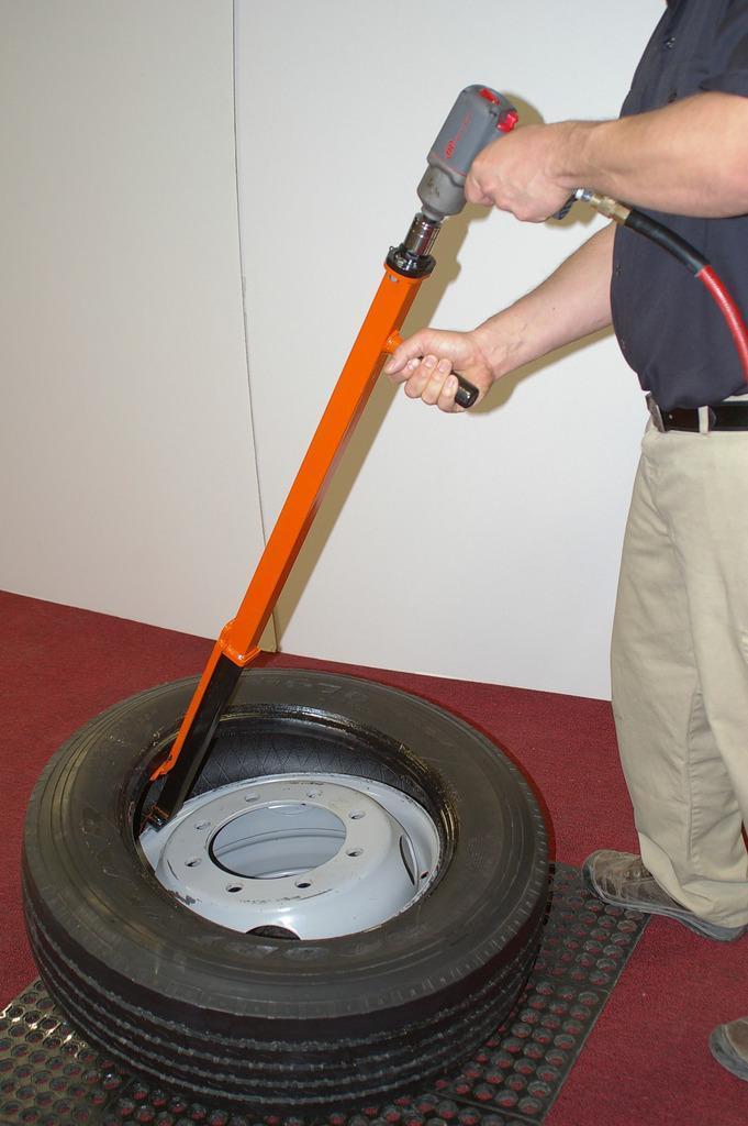 Pneu-Tek Impact Demounter in action removing a tire using an air impact wrench