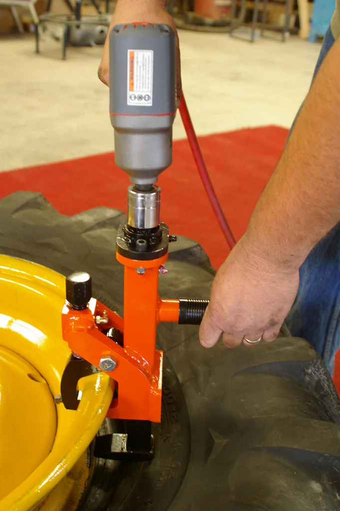 Using the Pneu-Tek Bead Breaker to separate tire bead from rim during tire service